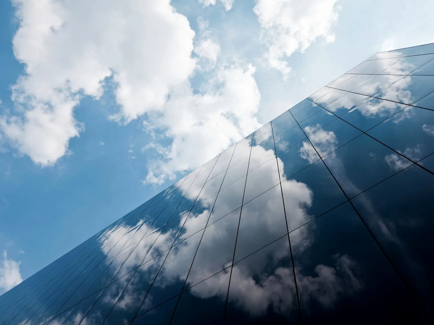 Glass tower reflecting clouds